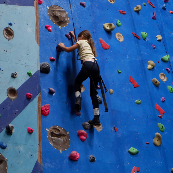 A child on a climbing wall.