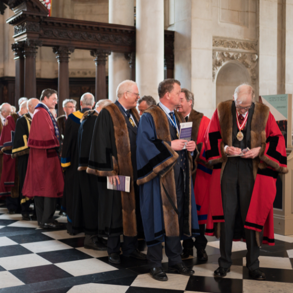Livery Masters, dressed in fine black, red and blue robes, preparing to process.