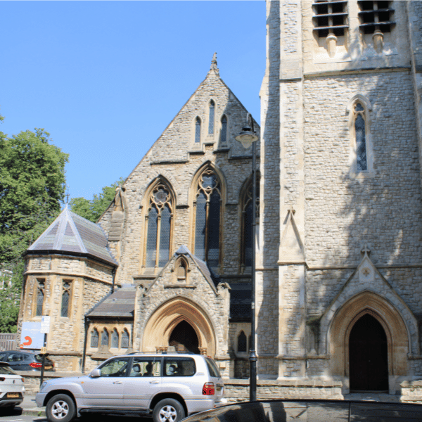 The exterior of St. Mellitus College, a brick church with stained glass windows.