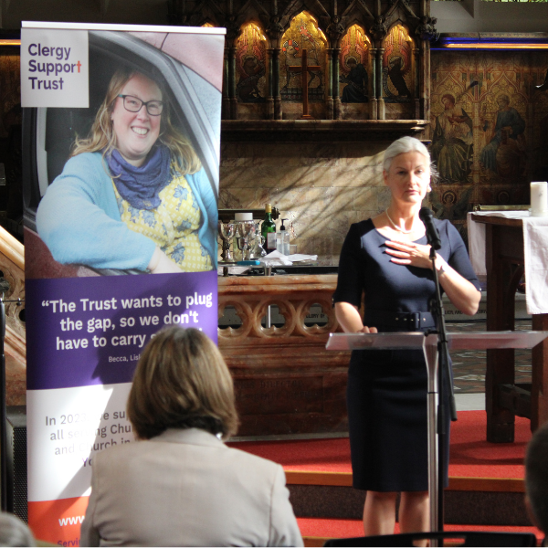 Dr Liz Graveling, standing behind a podium and delivering a speech.