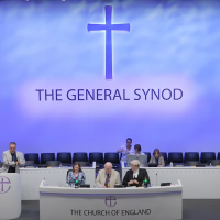 Officials sat behind a desk, at York Synod 2024.