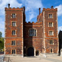 The exterior of Lambeth Palace, a red-bricked building against a blue sky.